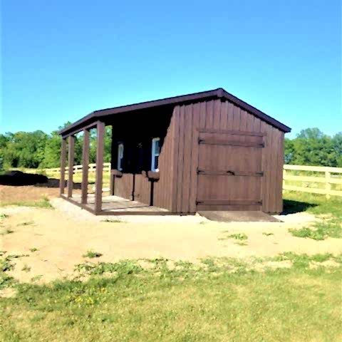 10 x 20 high board and batten with double doors and a 6 foot side porch.